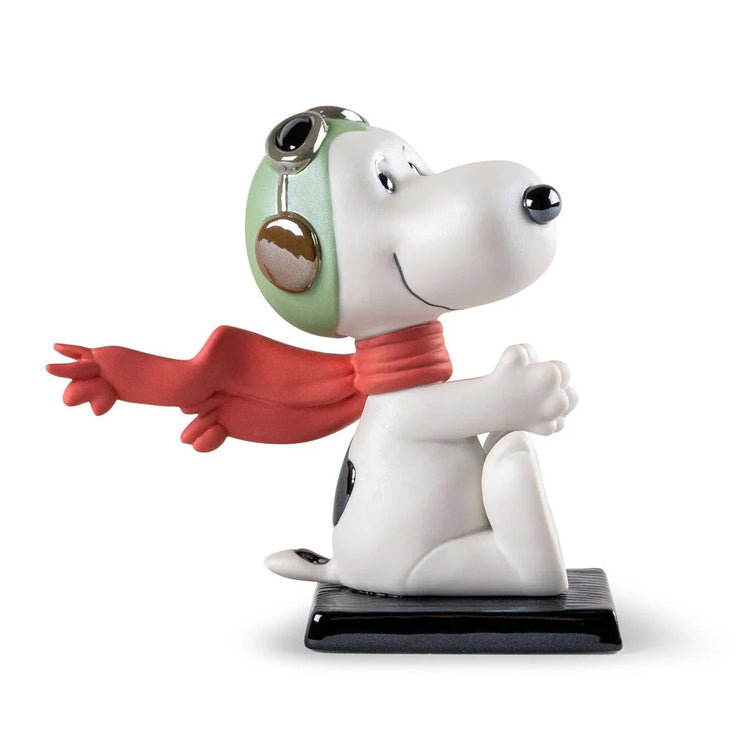 Snoopy ceramic figurine wearing green aviator helmet and red scarf on black base, pop culture collectible